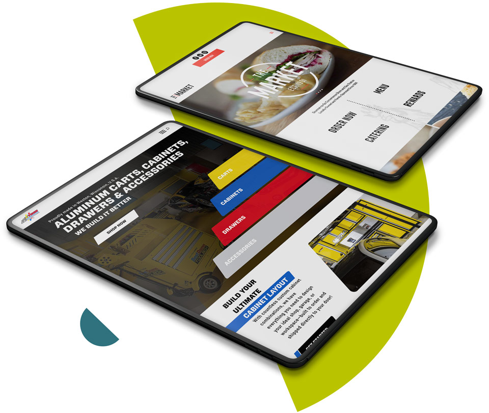 Two tablets laying on surface with mockup of websites
